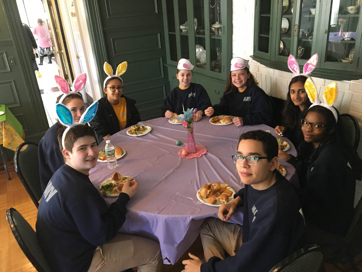 Egg Hunt Volunteers fundraising-volunteers-sitting-around-table-eating-with-bunny-ears-on