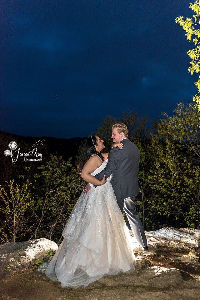 wedding couple embracing on overlook