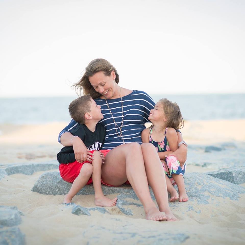 erica with her kids sitting on the beach