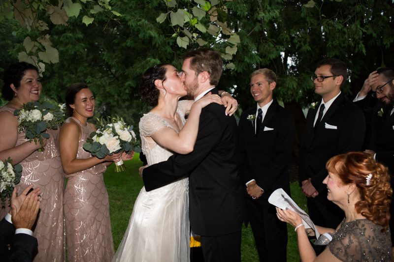 Outdoor Wedding Ceremony couple-kissing-after-art-deco-ceremony-under-the-grape-arbor